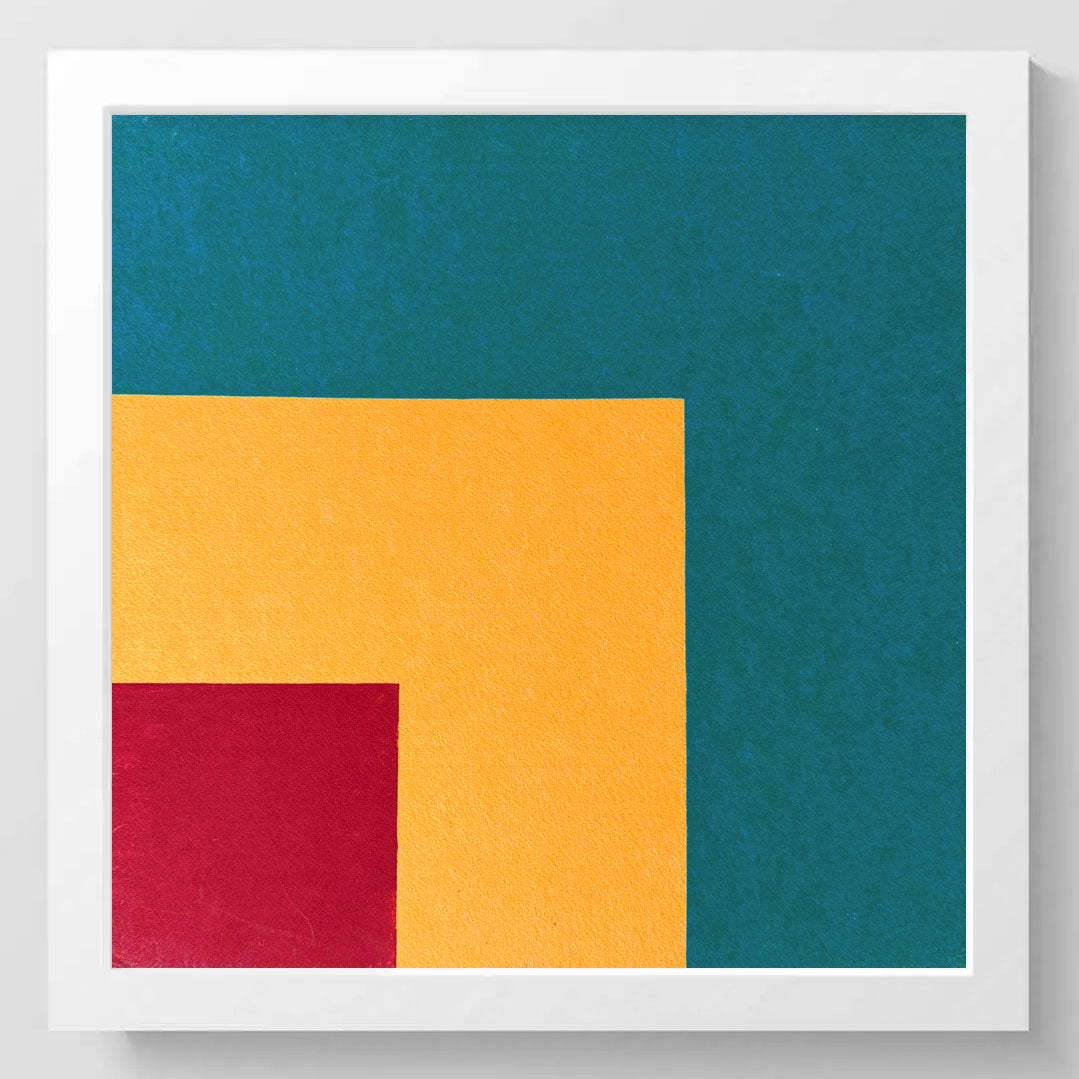A square abstract wall art print with a white frame, featuring geometric color blocks of teal, mustard yellow, and deep red on a white background.