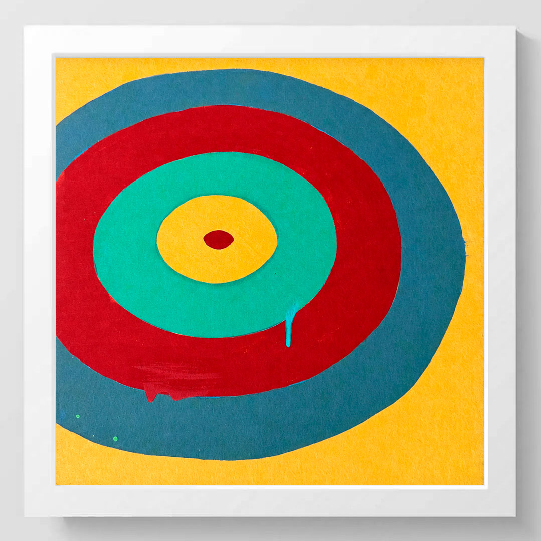 Framed abstract concentric circle art print featuring bold red, teal, yellow, and blue target-like rings on a yellow background, presented in a white square frame.