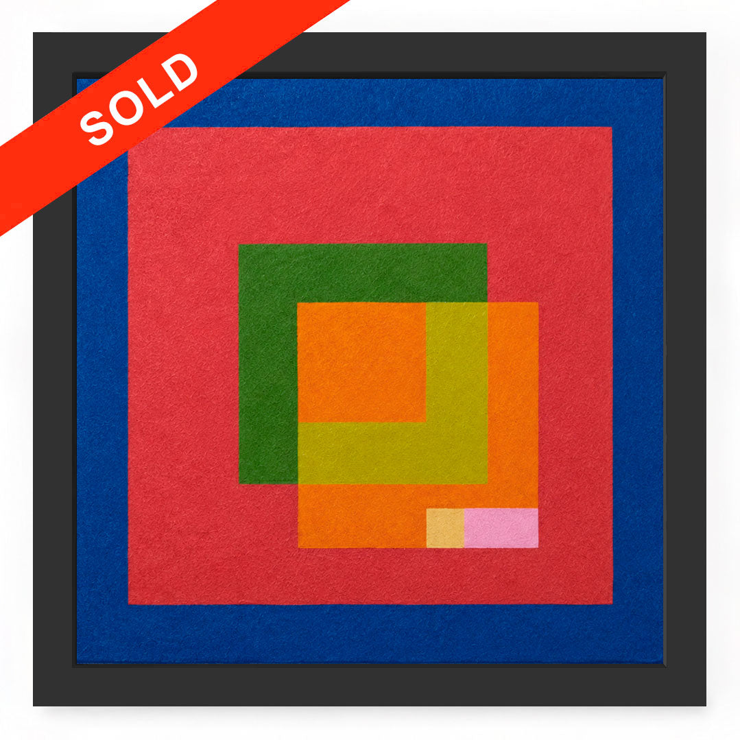A framed abstract geometric artwork with overlapping colored squares, featuring a large red field, blue border, green and orange shapes, and a small pink block, set in a dark frame. A bright red diagonal banner across the top left reads “SOLD.