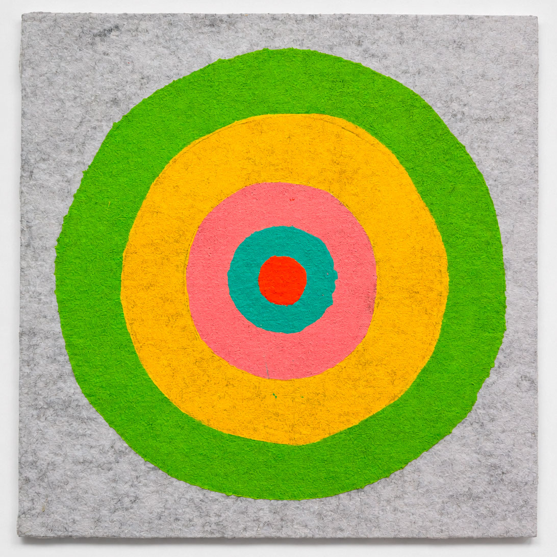 A square textured gray canvas featuring a concentric target design with rings of green, yellow, pink, teal, and red.