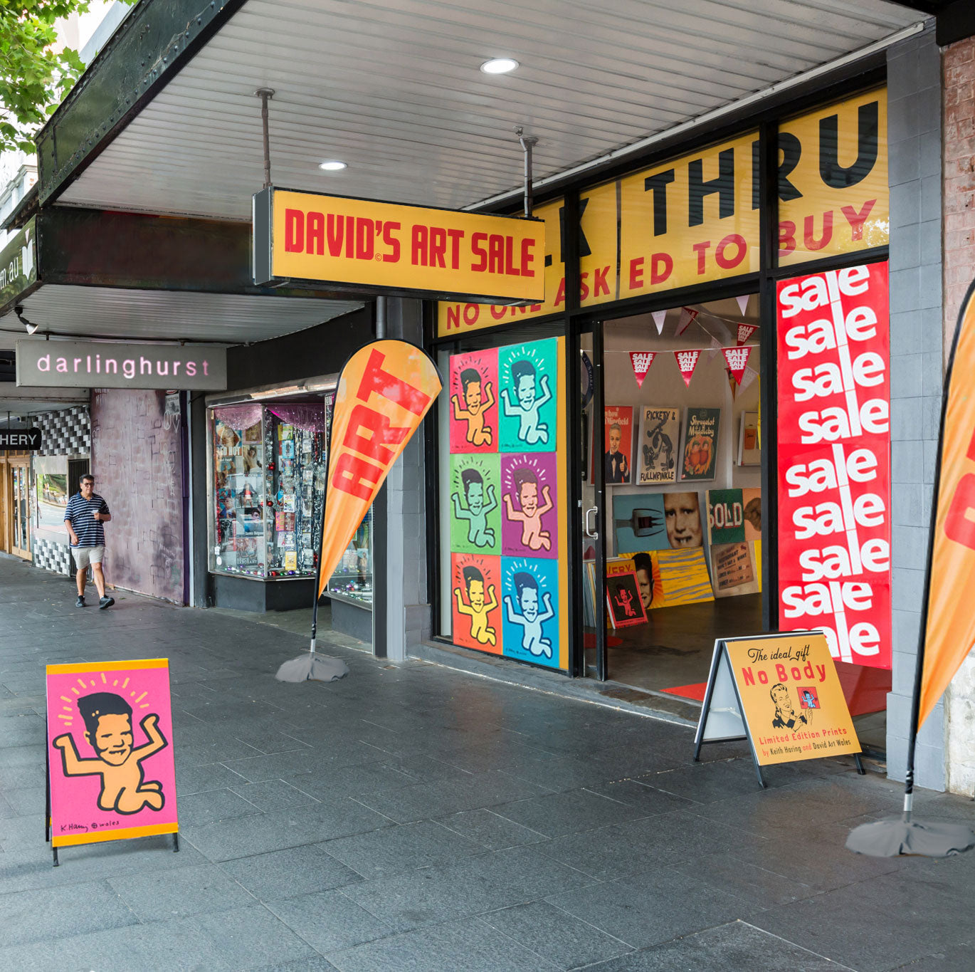 Street storefront scene for David's Art Sale with large yellow sale signs, colorful pop-art posters on the glass, and orange promotional flags on a paved sidewalk.